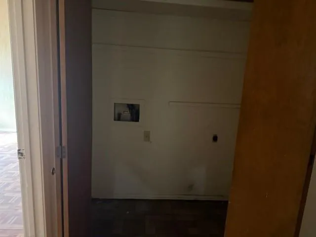 a view of a room has wooden walls and a window