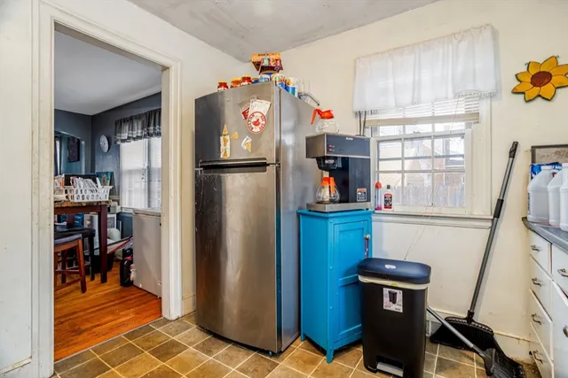 a view of storage and utility room with fridge and workspace