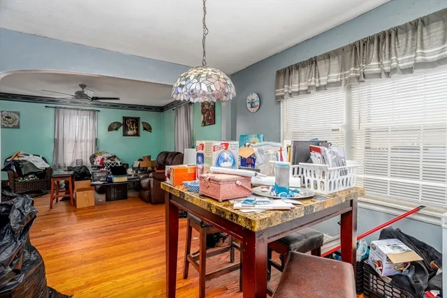 a view of a dining room with furniture a chandelier and wooden floor