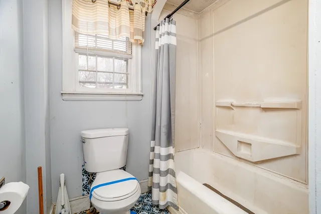 a white toilet sitting next to a bathroom sink