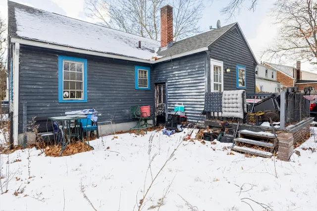 a view of a house with snow on the road