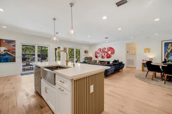 a dining room with furniture a window and appliances