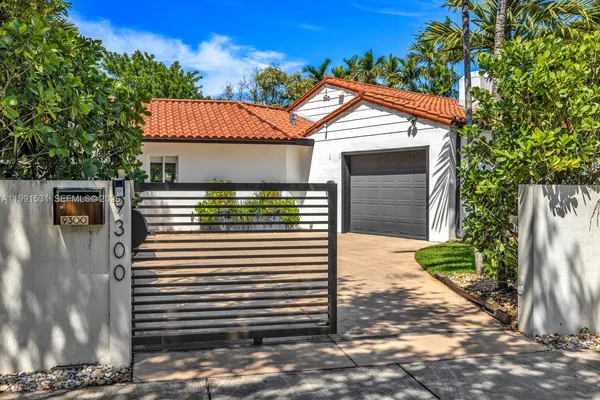 a view of a house with a yard and sitting area