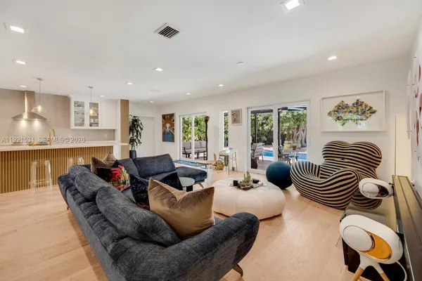 a kitchen with stainless steel appliances granite countertop a stove and a wooden floors