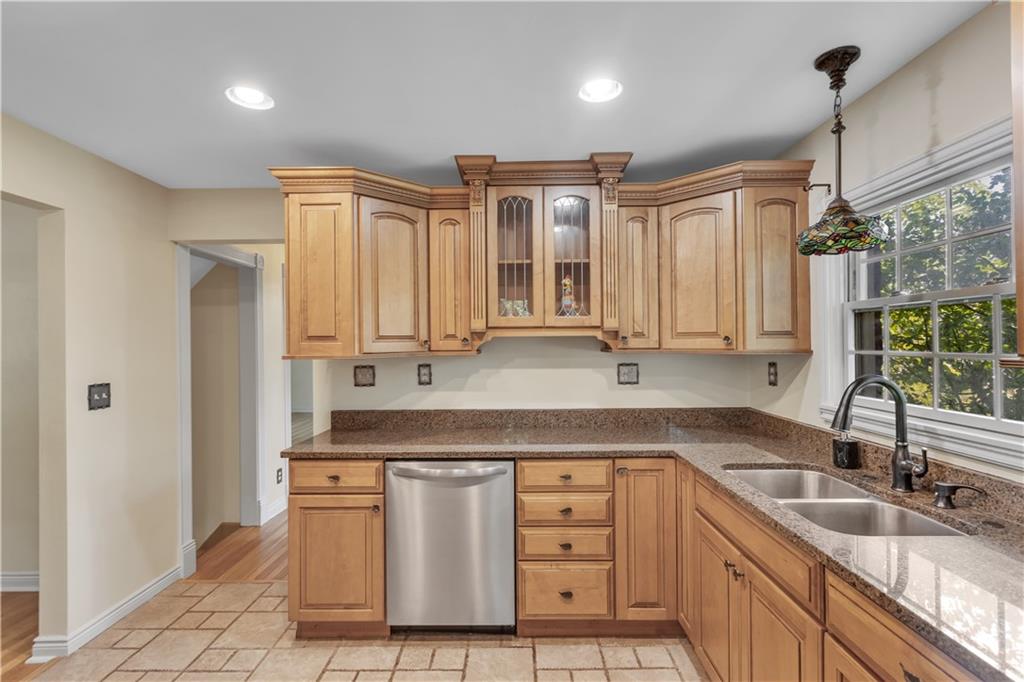 2753 Rochester Road Cranberry Township, PA 16066 - Photo 12 of 38 a kitchen with stainless steel appliances granite countertop a sink a stove and a refrigerator