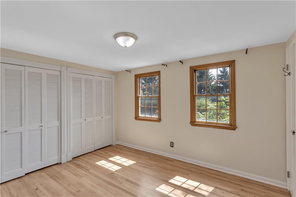 2753 Rochester Road Cranberry Township, PA 16066 - Photo 23 of 38 a view of an empty room with wooden floor and a window