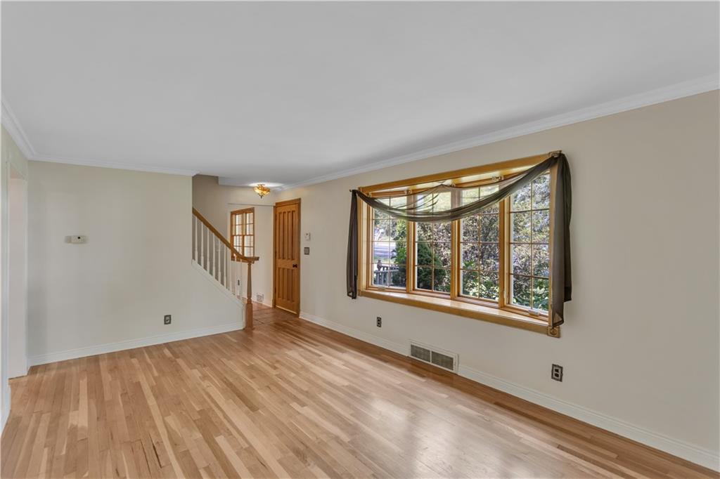 2753 Rochester Road Cranberry Township, PA 16066 - Photo 4 of 38 an empty room with wooden floor and windows