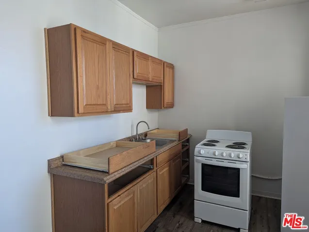 a kitchen with stainless steel appliances a refrigerator sink and cabinets