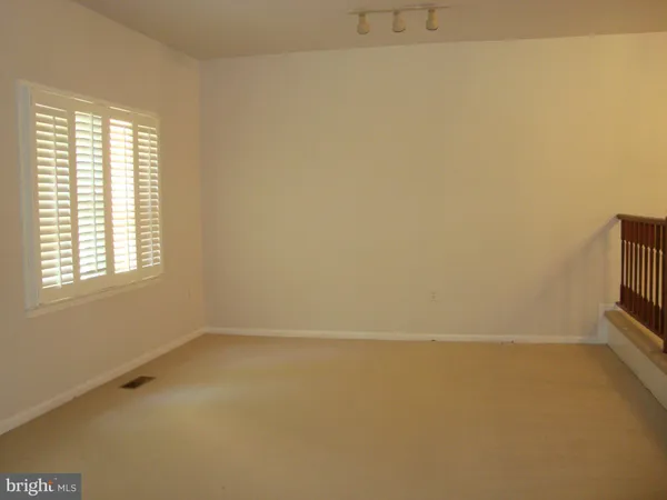 an empty room with a empty space and a window