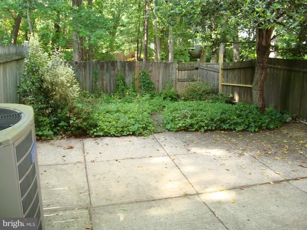 a backyard of a house with lots of green space and lake view