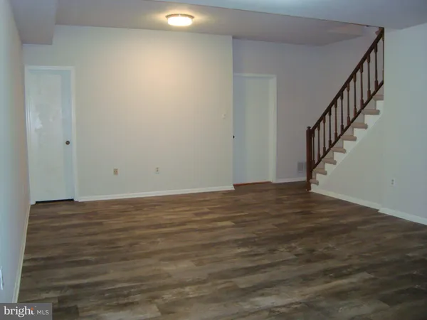 a view of an empty room and wooden floor