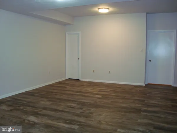 an empty room with wooden floor