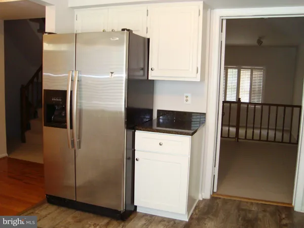 a kitchen with a refrigerator and a window