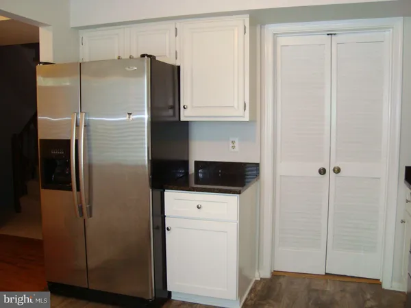 a kitchen with stainless steel appliances a refrigerator and cabinets
