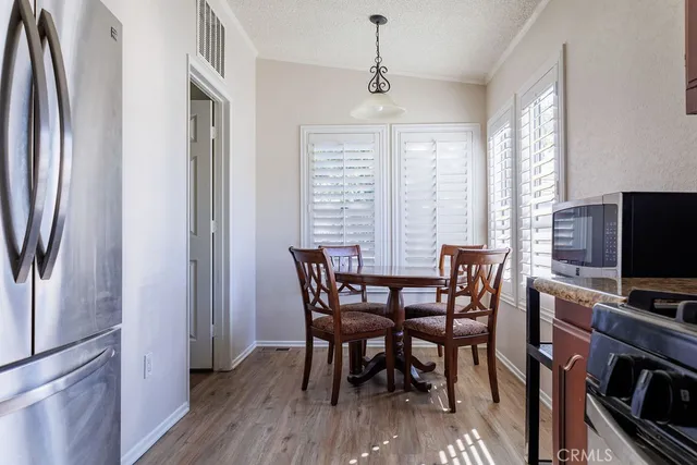 a view of a dining room with furniture window and wooden floor