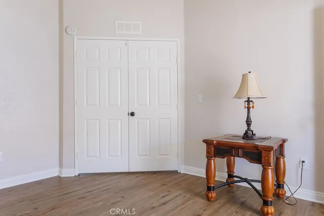 a view of a room with a table and wooden floor