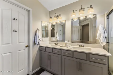 a bathroom with a double vanity sink and a mirror