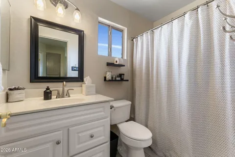a bathroom with a toilet a sink and a mirror