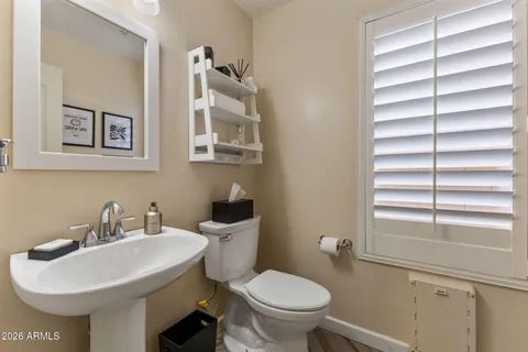 a bathroom with a sink toilet and a mirror