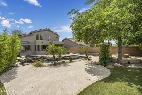a view of a house with backyard porch and sitting area