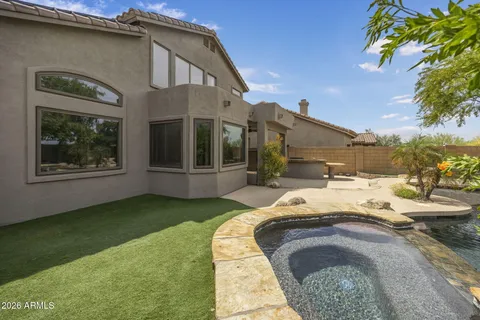 a view of a house with backyard and sitting area