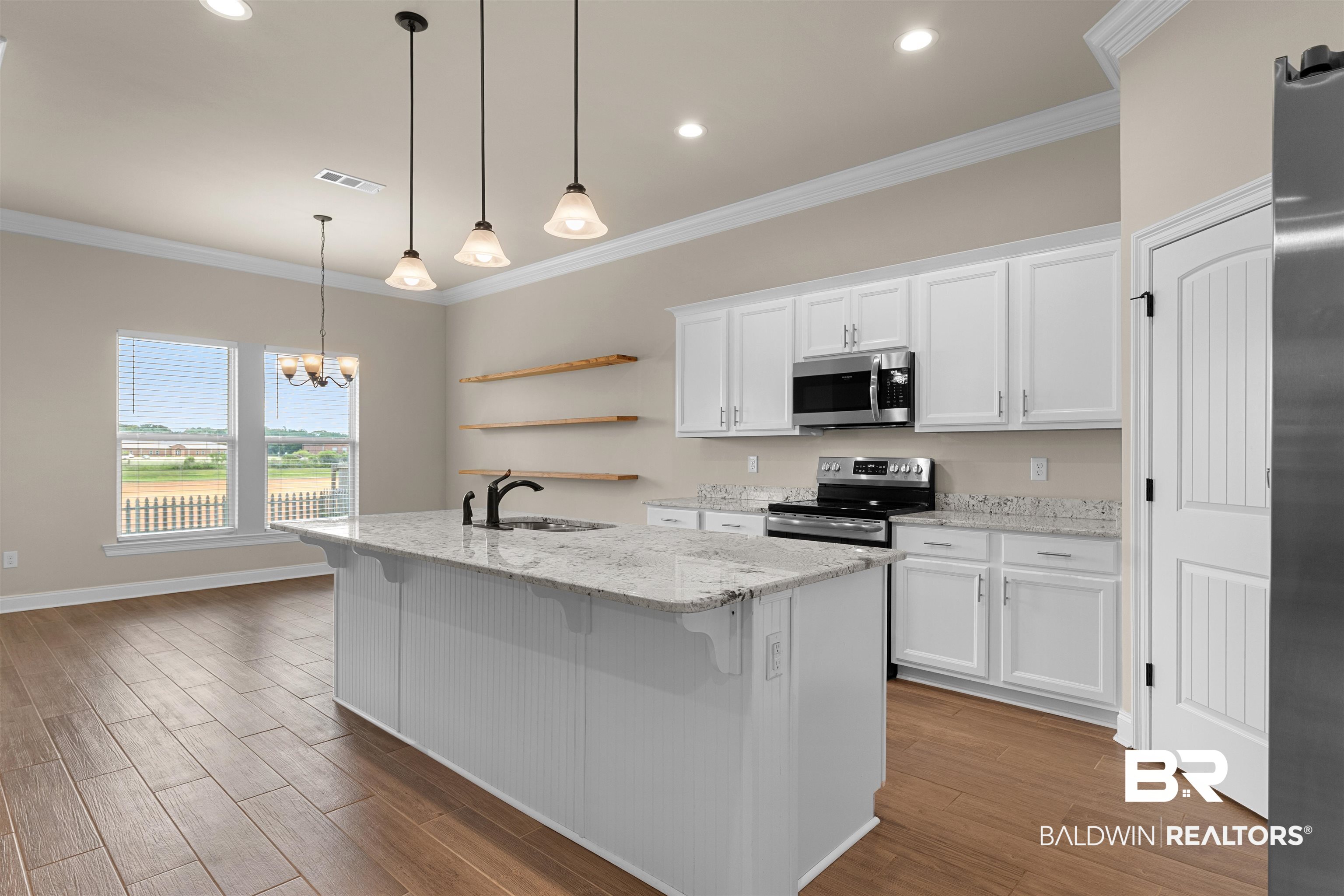 991 Dalton Circle Foley, AL 36535 - Photo 7 of 35 Kitchen featuring appliances with stainless steel finishes, open shelves, white cabinets, wood finished floors, and crown molding