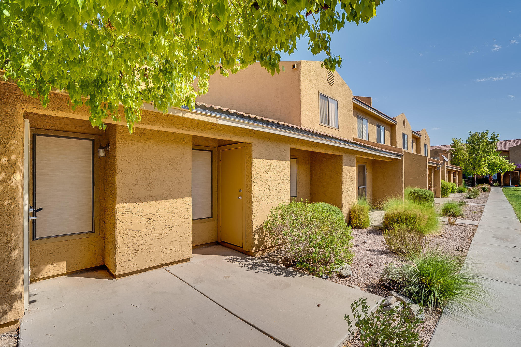 3511 East Baseline Road, Unit 1122 Phoenix, AZ 85042 - Photo 1 of 21 front view of a house with a yard