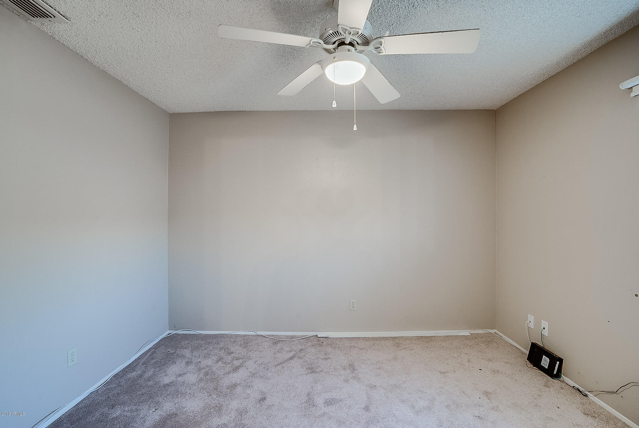 3511 East Baseline Road, Unit 1122 Phoenix, AZ 85042 - Photo 11 of 21 an empty room with a fan & a window