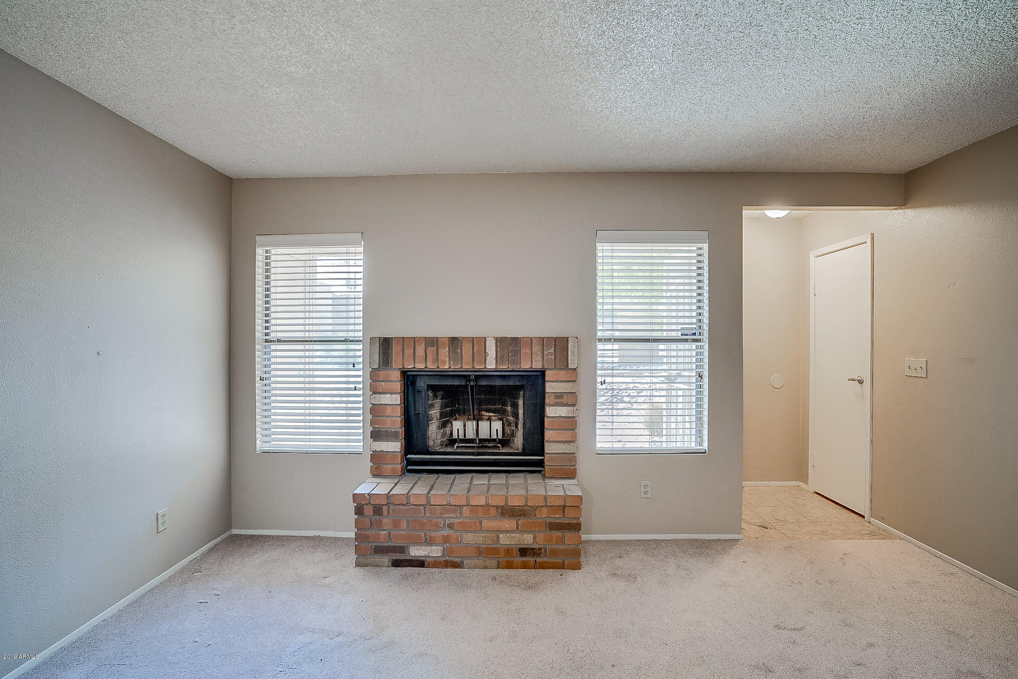 3511 East Baseline Road, Unit 1122 Phoenix, AZ 85042 - Photo 2 of 21 a living room with furniture and a fireplace