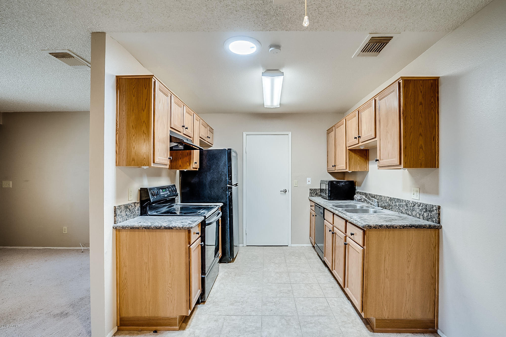 3511 East Baseline Road, Unit 1122 Phoenix, AZ 85042 - Photo 3 of 21 a kitchen with stainless steel appliances granite countertop a sink stove and refrigerator