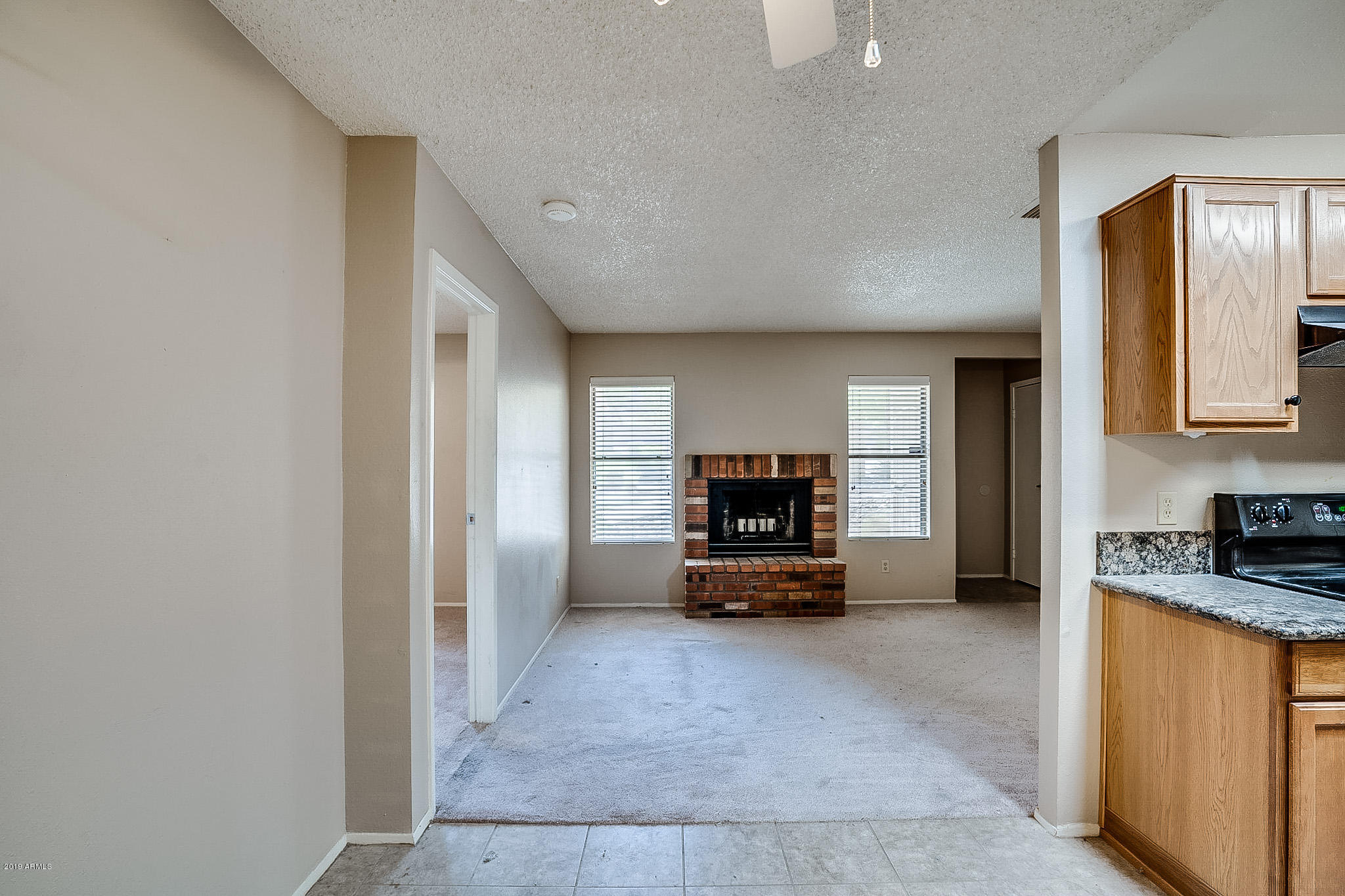 3511 East Baseline Road, Unit 1122 Phoenix, AZ 85042 - Photo 8 of 21 a view of kitchen with flat screen tv and refrigerator