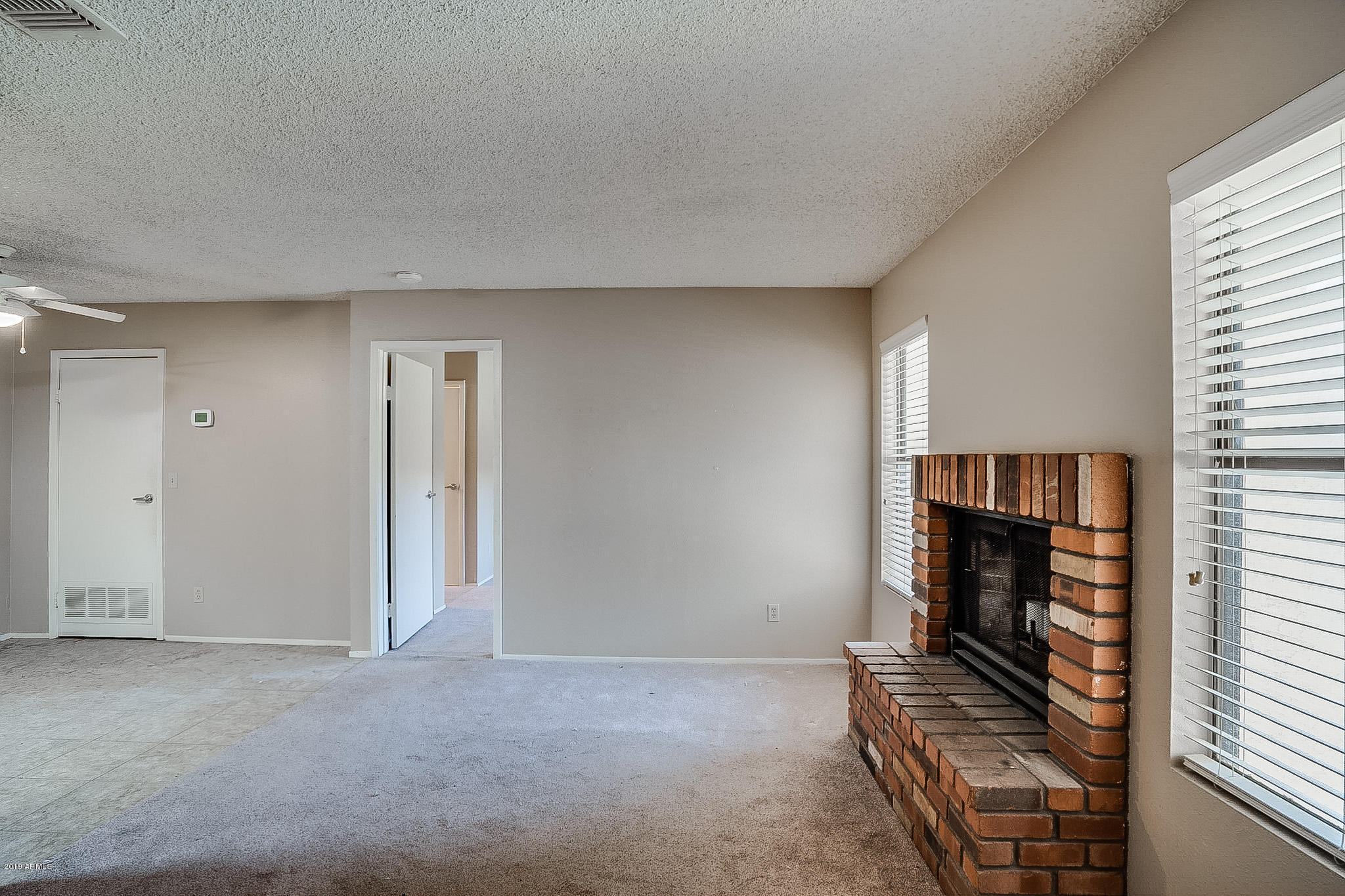 3511 East Baseline Road, Unit 1122 Phoenix, AZ 85042 - Photo 10 of 21 a view of an empty room with a fireplace