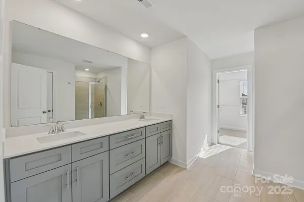 a bathroom with a double vanity sink mirror and
