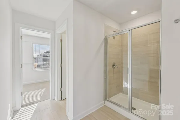 a bathroom with a glass shower door