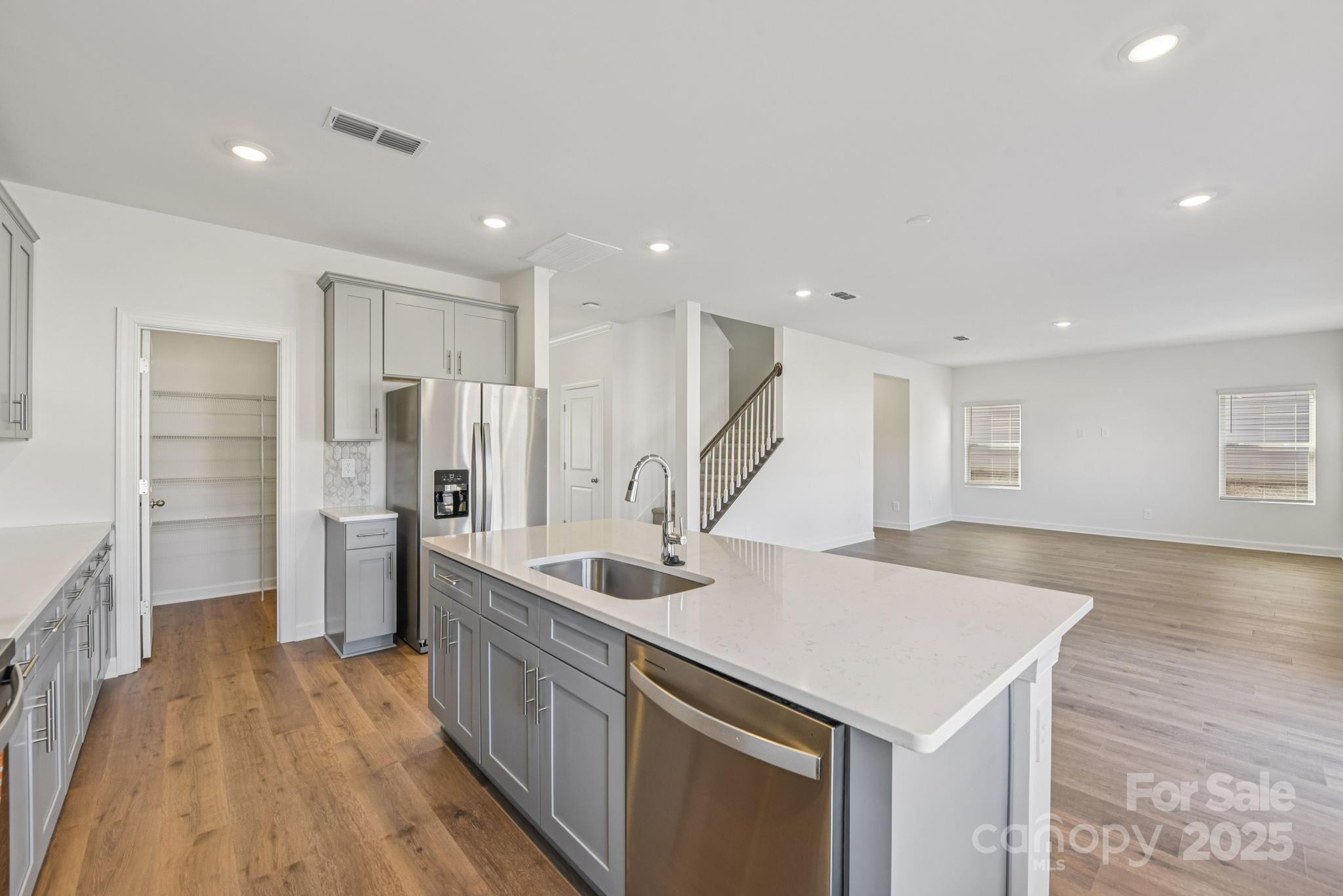 167 Murphy Mdw Road Mocksville, NC 27028 - Photo 4 of 28 a kitchen with stainless steel appliances a sink and wooden floor