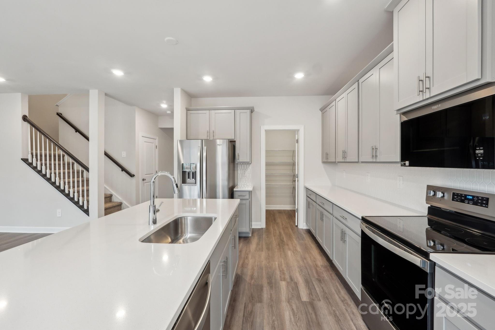 167 Murphy Mdw Road Mocksville, NC 27028 - Photo 4 of 21 a kitchen with stainless steel appliances granite countertop a sink a stove and a refrigerator