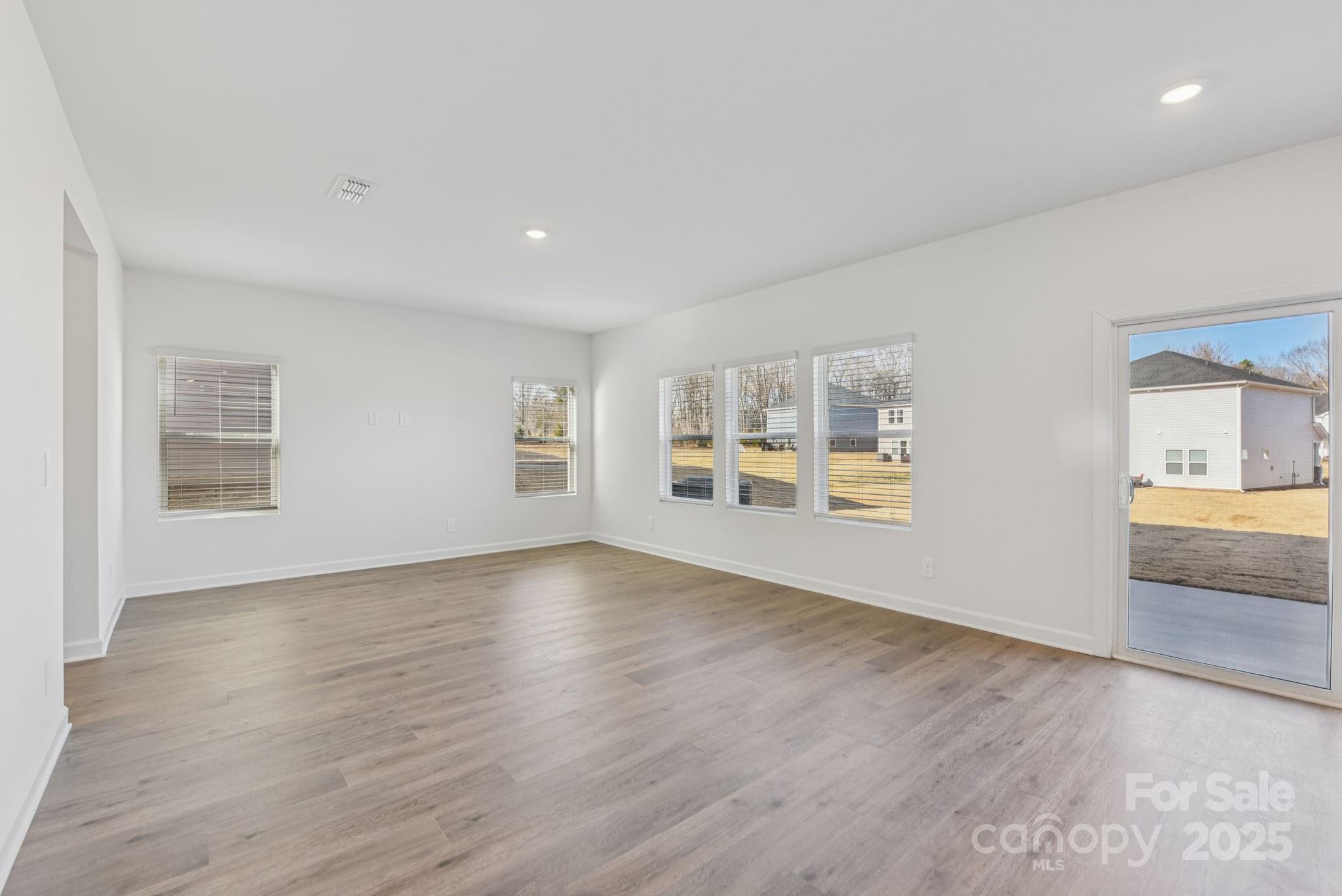 167 Murphy Mdw Road Mocksville, NC 27028 - Photo 8 of 28 a view of empty room with wooden floor and fan