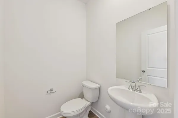 a bathroom with a sink a toilet and mirror