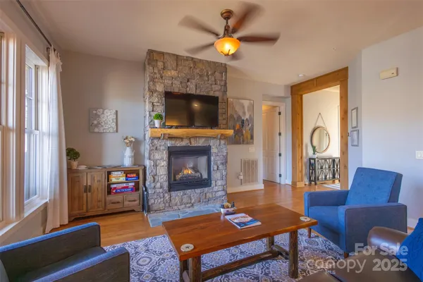 a living room with furniture a flat screen tv and a fireplace