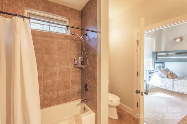 a bathroom with a granite countertop shower a toilet and a sink