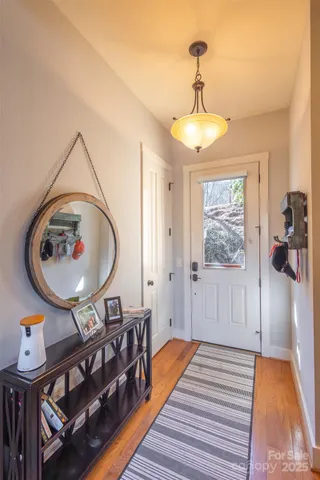 a view of a livingroom with furniture wooden floor and a chandelier