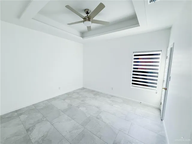 an empty room with a empty space and a ceiling fan