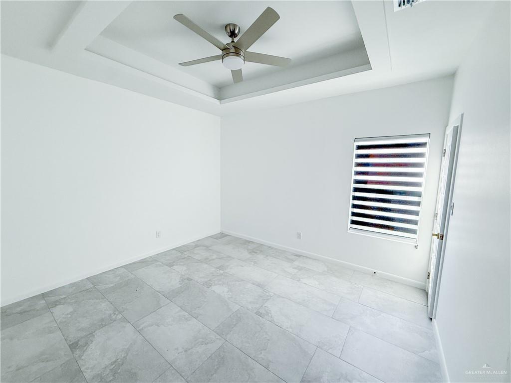 2104 Cassandra Street, Unit 3 Mission, TX 78572 - Photo 12 of 15 an empty room with a empty space and a ceiling fan