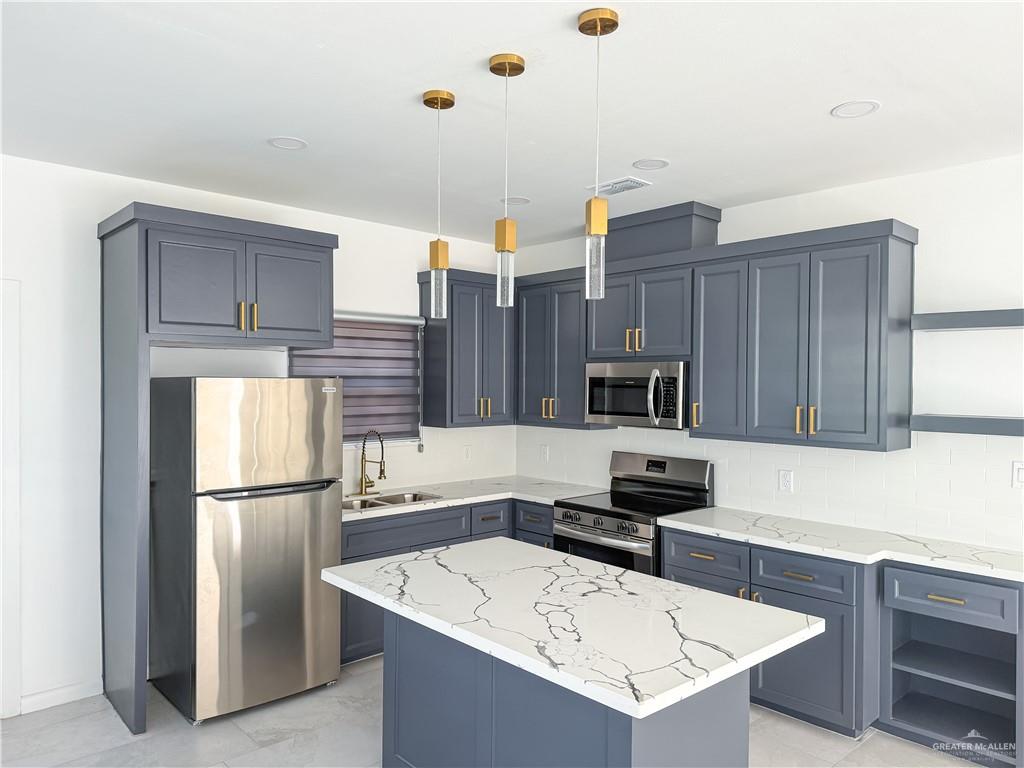 2104 Cassandra Street, Unit 3 Mission, TX 78572 - Photo 5 of 15 a kitchen with a sink a refrigerator and cabinets