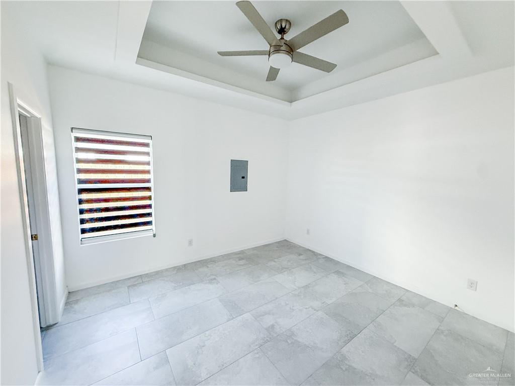 2104 Cassandra Street, Unit 3 Mission, TX 78572 - Photo 9 of 15 an empty room with a window and ceiling fan