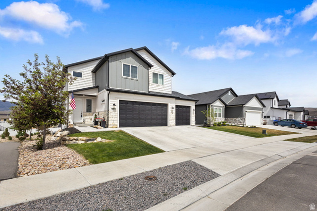 7889 Bristlecone Road Eagle Mountain, UT 84005 - Photo 1 of 42 Two-story contemporary residence featuring white siding and gray vertical panel accents