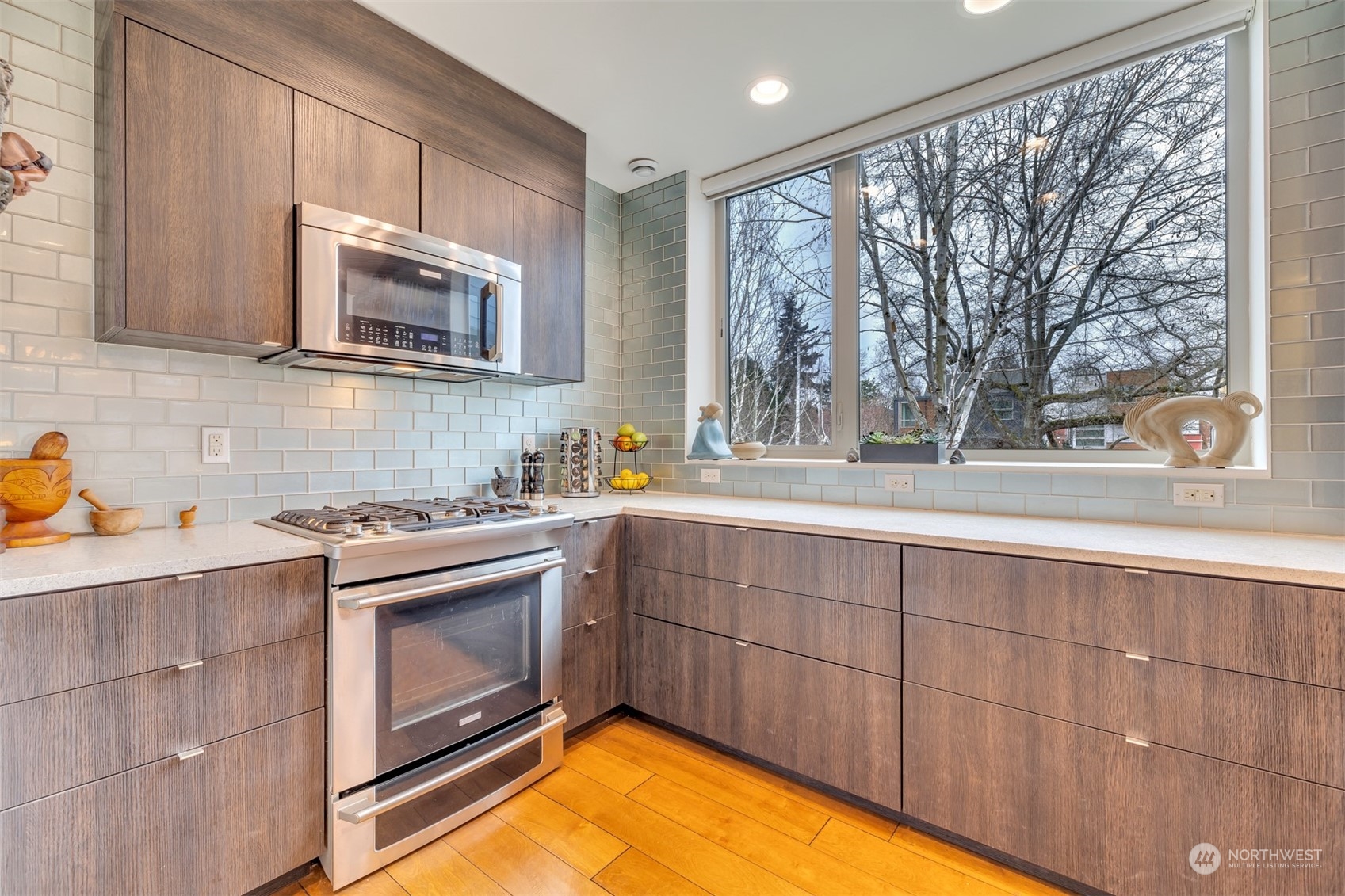 4457 Renton Avenue South Seattle, WA 98108 - Photo 3 of 40 a kitchen with stainless steel appliances granite countertop a stove a sink and a microwave