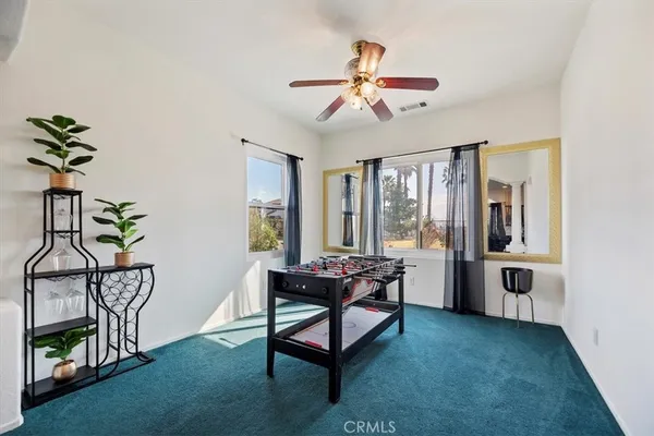 a dining room with furniture and wooden floor