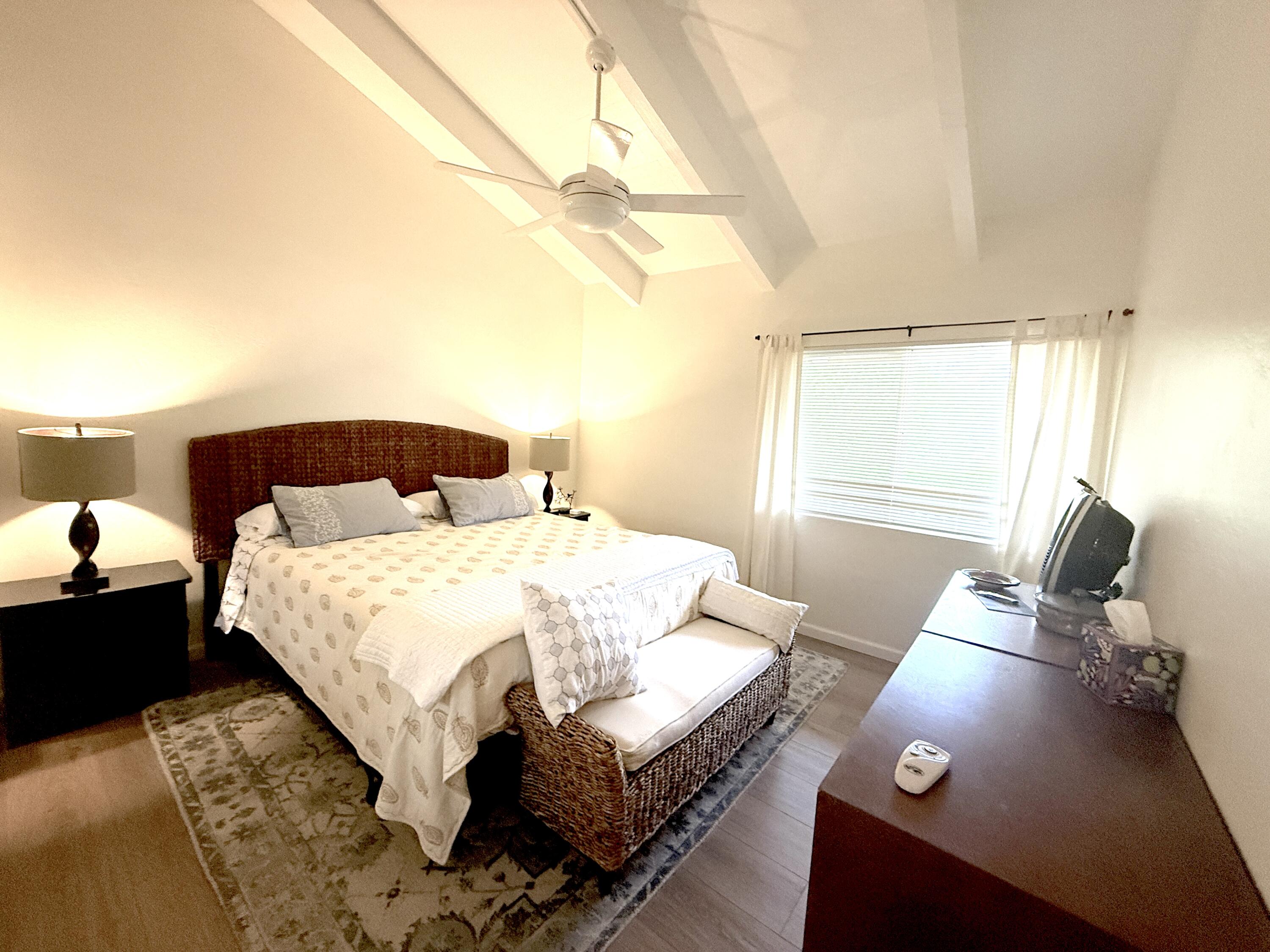 29 Dearborn Place, Unit 10 Goleta, CA 93117 - Photo 5 of 7 a bedroom with a bed and wooden floor