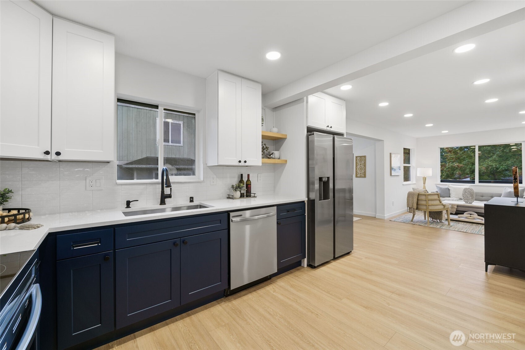 7004 16th Avenue Southwest Seattle, WA 98106 - Photo 15 of 37 a kitchen with stainless steel appliances granite countertop a sink refrigerator and cabinets